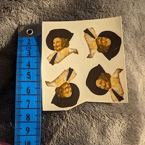 May include: Four vintage paper stickers featuring a man in a black hat and a white collar. The man is smiling and has a mustache. The stickers are on a white background.