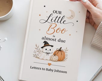 May include: A hardcover book with a cream-colored cover featuring the text Our Little Boo is almost due and Letters to Baby Johnson. The cover art displays a ghost wearing a witch hat, a pumpkin, a crescent moon, and small stars.