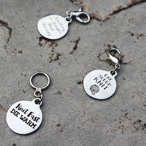 May include: Three silver keychains with different sayings. The first keychain says "Knitting is cheaper than therapy". The second keychain says "Eat Sleep Knit" with a small knit stitch design. The third keychain says "Knit Fast Die Warm".