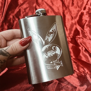 Stainless steel flask with a hand engraved playboy bunny.