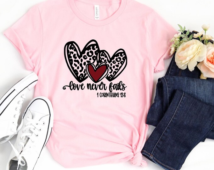 Love Never Fails Valentines Day Shirt, Leopard Heart Christian Sweatshirt, 1 Corinthians 13:8 Bible Verse Shirt, Faith-Inspired Gift for Her