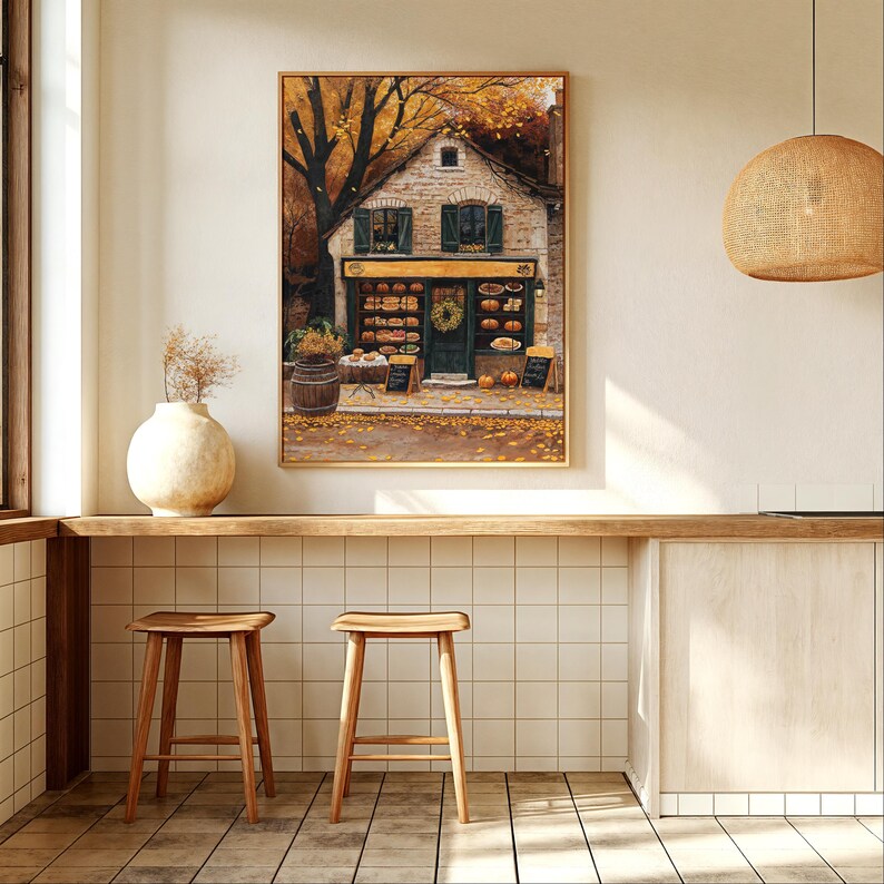 May include: A painting of a small brick building with a green door and windows. The building has a sign that says "Bakery" and is surrounded by fall foliage. There are baskets of bread and other baked goods in the windows.