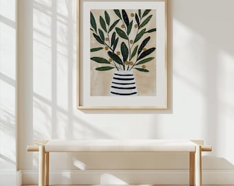 May include: A framed art print featuring a stylized illustration of olive branches in a vase. The vase is white with horizontal black stripes. The olive branches have green leaves and small, round, golden-yellow olives. The artwork is in a light wood frame.