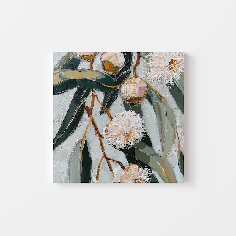 May include: Square canvas art featuring a close-up of eucalyptus branches with green leaves, brown stems, and white and peach-colored flowers. The painting has a textured, impasto style with visible brushstrokes.