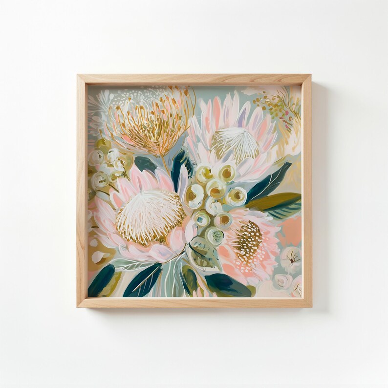 May include: Square framed floral art print featuring a bouquet of protea flowers in shades of pink, gold, and green. The artwork is set against a soft, light background, and the frame is made of natural wood.