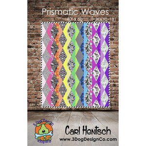 May include: A colorful quilt titled "Prismatic Waves" with a diamond pattern. The quilt measures 40" x 50" and features a variety of patterns and colors, including pink, orange, yellow, green, gray, blue, and purple. The quilt is displayed against a brick wall.