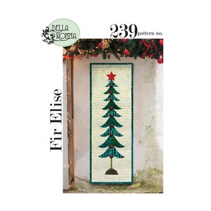 May include: A rectangular Christmas tree quilt with a red star on top. The tree is green with red ornaments and a brown trunk. The text "Fir Elise" and "239 pattern no." are visible.