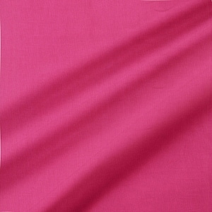 May include: A close-up shot of a vibrant fuchsia fabric with subtle texture. The fabric is draped, creating soft folds and shadows that add depth to the solid color. The material appears to be smooth and possibly lightweight.