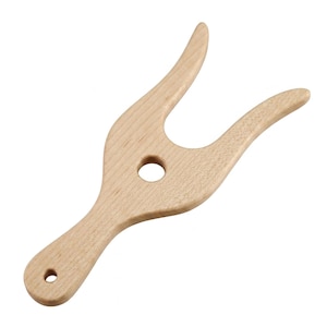 May include: A light-colored wooden boot jack featuring a Y-shaped design with two curved prongs at the top, a central circular cutout, and a handle at the bottom with a small hole for hanging. The wood grain is visible across the smooth surface.
