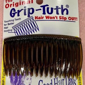 May include: A brown plastic hair comb with the text "The Original Grip-Tuth" and "Hair Won't Slip Out!" on the packaging. The comb is designed to hold hair in place and features a row of teeth that are close together. The packaging also includes the text "Good Hair Days" and "Best!"