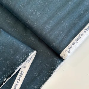 May include: Dark teal fabric with a subtle, repeating floral pattern. The fabric is folded, revealing a raw edge and a white selvedge with the text "Nature Study 2.0 by Whistler Studios" and "STYLE # 54686".