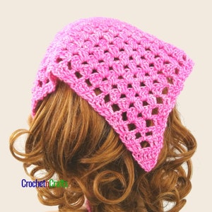 May include: A pink crocheted bandana with a square pattern. The bandana is tied around a person's head.