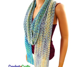 May include: A crocheted scarf with a gradient of blue, green, and yellow colors. The scarf is draped around a mannequin's neck.