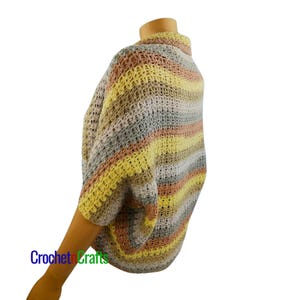 May include: A striped crochet cardigan with a high neck and short sleeves. The cardigan is made in a variety of colors, including pink, yellow, and gray.