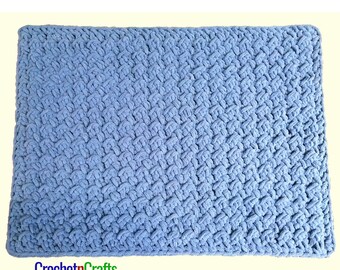 May include: A blue crocheted blanket with a textured pattern. The blanket is made with a soft yarn and has a smooth, even texture.