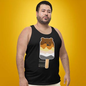 May include: Black tank top featuring a bear-shaped popsicle design with brown, tan, yellow, and gray layers. The popsicle is on a wooden stick, and the words "CHILL OUT" are printed vertically on the side.