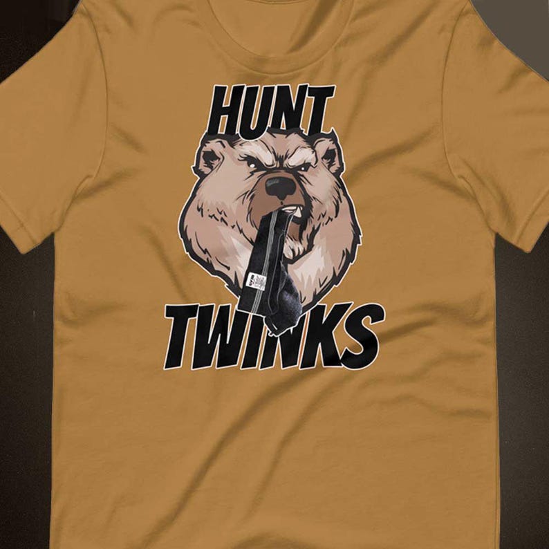 May include: A brown t-shirt with a cartoon bear wearing a black sock in its mouth. The text "HUNT TWINKs" is printed on the shirt.