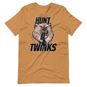 May include: A mustard yellow t-shirt with a black bear graphic. The bear is wearing a black sock and has the words "HUNT TWINKs" printed on the shirt.
