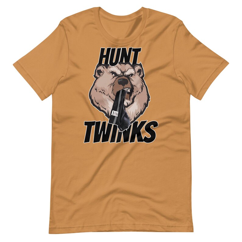 May include: A mustard yellow t-shirt with a black bear graphic. The bear is wearing a black sock and has the words "HUNT TWINKs" printed on the shirt.