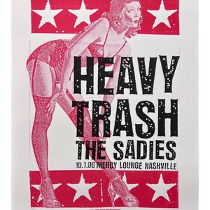 May include: A pink and white concert poster featuring a pin-up style illustration of a woman in a red dress and black stockings. The poster advertises a concert for "Heavy Trash" and "The Sadies" on 1 October 2006 at the Mercy Lounge in Nashville.