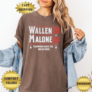 May include: A brown t-shirt with the text "Wallen 20 Malone 24" in red and white. The text "Teamwork makes the dream work" is below the names in black.