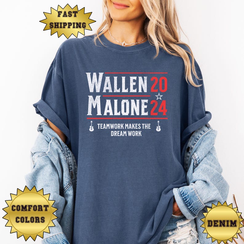 May include: A navy blue t-shirt with a white graphic print that reads "Wallen 20 Malone 24" with a star and a guitar graphic. The text below the graphic reads "Teamwork makes the dream work".