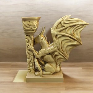 A 3D-printed Dragon Bookend, featuring intricate wings, fierce claws, and customizable color options. This mythical dragon bookend is both decorative and functional, perfect for fantasy lovers, book collectors, and unique bookshelf organization.