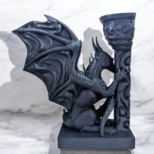 A 3D-printed Dragon Bookend, featuring intricate wings, fierce claws, and customizable color options. This mythical dragon bookend is both decorative and functional, perfect for fantasy lovers, book collectors, and unique bookshelf organization.