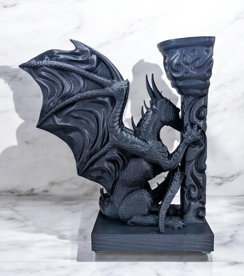 A 3D-printed Dragon Bookend, featuring intricate wings, fierce claws, and customizable color options. This mythical dragon bookend is both decorative and functional, perfect for fantasy lovers, book collectors, and unique bookshelf organization.