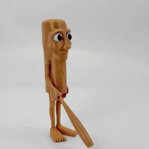 May include: A brown figurine of a person with a long, thin body and large eyes. The figurine is holding a wooden baseball bat.