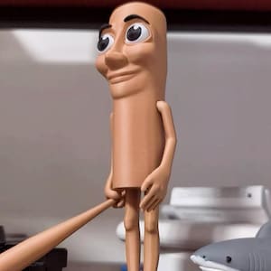 May include: A tan-colored figurine with a human-like face and large eyes. The figurine has long, thin legs and is holding a stick in its hands.