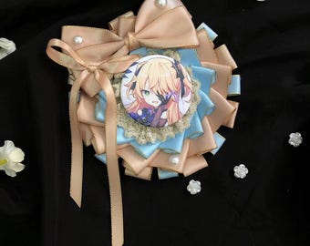 May include: A light blue and peach colored bow with a white pearl in the center. The bow has a small round pinback with a cartoon image of a girl with blonde hair and blue eyes. The girl is wearing a blue and white dress and a black choker.