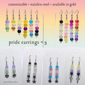 May include: A collection of beaded pride earrings in various colors, including rainbow and pastel shades. The earrings are made of stainless steel and are available in gold. The text "pride earrings <3" is displayed.