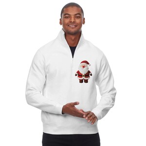 May include: White quarter-zip sweatshirt with a small Santa Claus graphic on the chest. The Santa Claus graphic features a red hat and coat, a white beard, and brown boots. The sweatshirt has a high collar and a black zipper.