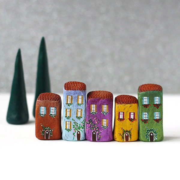 Little Italian village with five clay houses and two cypress trees
