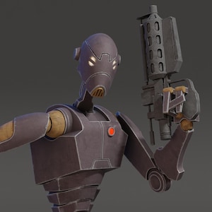 May include: A dark gray robotic figure with a smooth, rounded head, glowing eyes, and a segmented torso. The figure features tan-colored joints and a small red circular emblem on the chest, while holding a dark gray mechanical blaster weapon.