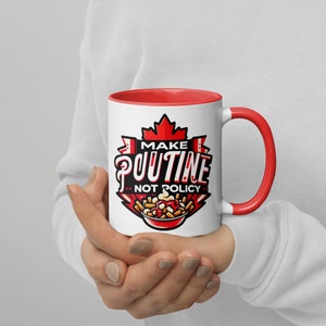 May include: White ceramic mug with a red rim and handle. The mug features a red and white Canadian flag design with the text "Make Poutine Not Policy" and a cartoon image of poutine.