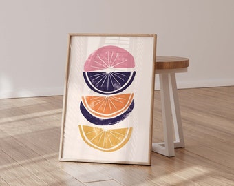 May include: A digital print of a stack of four citrus fruit slices in a modern abstract style. The slices are pink, purple, orange, and yellow. The print is framed and displayed on a white wall.