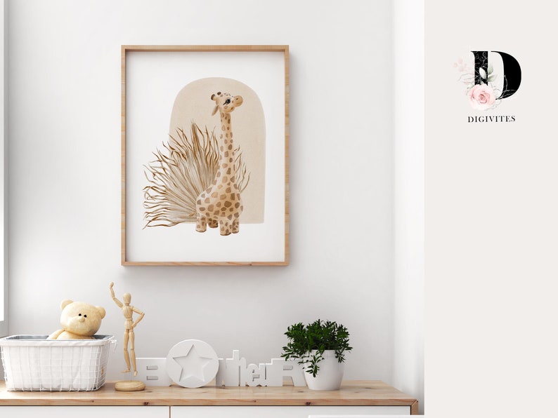 May include: A framed print of a watercolor illustration of a giraffe standing in front of a tan archway with a brown and tan grass-like plant behind it. The print is on a white background and has a wooden frame.