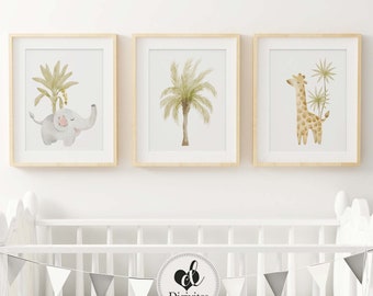 May include: Three framed watercolor prints featuring a grey elephant with a palm tree, a green palm tree, and a brown giraffe with a palm tree. The prints are displayed on a white wall above a white crib with a grey and white bunting.