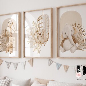 May include: Three framed prints with watercolor illustrations of a giraffe, a bear in a hanging chair, and an elephant. The prints have a neutral color palette of beige, brown, and white. The prints are hung on a white wall with a string of flags.