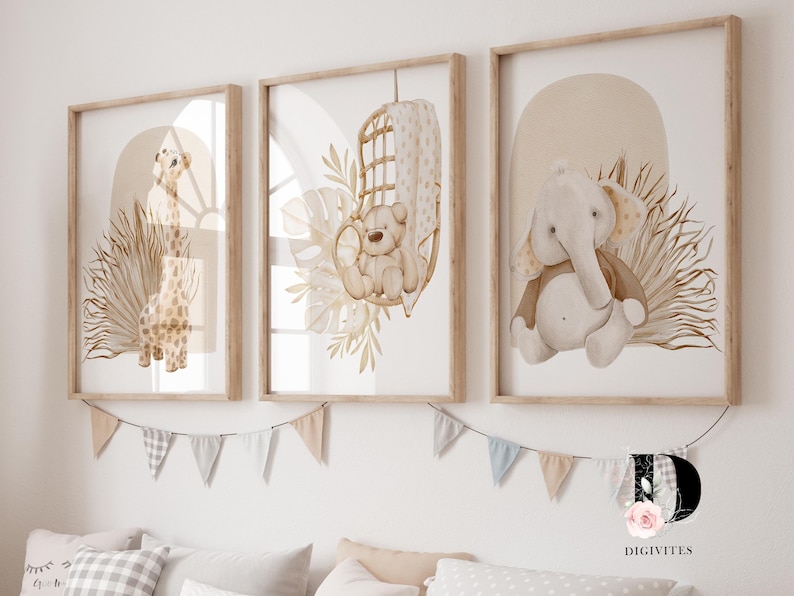 May include: Three framed prints with watercolor illustrations of a giraffe, a bear in a hanging chair, and an elephant. The prints have a neutral color palette of beige, brown, and white. The prints are hung on a white wall with a string of flags.