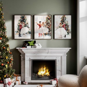 May include: Three framed watercolor paintings depicting a couple dancing under a Christmas tree. The paintings are hung on a wall above a white marble fireplace with a fire burning inside.