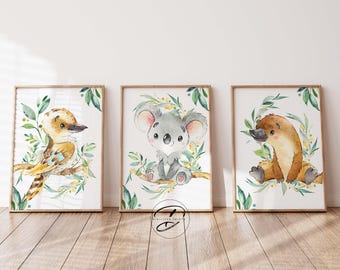 May include: Three watercolor illustrations of Australian animals: a kookaburra, a koala, and a platypus. Each animal is surrounded by green leaves and yellow flowers.