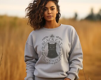May include: A light grey sweatshirt with a black cat illustration inside a circular design. The text "BLACK CAT SOCIETY 16 92" is printed around the cat image. The sweatshirt is a crew neck style.