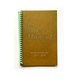 May include: A brown spiral-bound notebook with the words "In This Thread" and "Collected Reddit 2017-2019" printed on the cover. The spiral binding is a light green color.