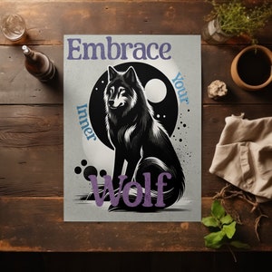 May include: A poster with a black and white wolf illustration. The text "Embrace Your Inner Wolf" is in purple and blue. The wolf is set against a black circle with a white moon. The poster is on a wooden surface.