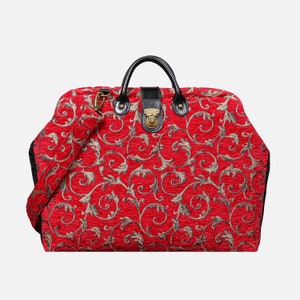 May include: A red and gold patterned handbag with a black handle and shoulder strap. The bag features a decorative clasp and a repeating floral design. The bag is approximately 16 inches wide and 10 inches tall.