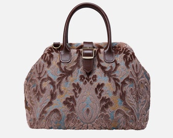 May include: A brown leather handbag with a floral patterned fabric exterior. The bag has a top handle and a buckle closure.