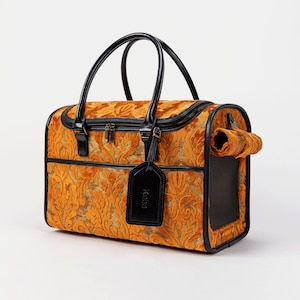 May include: A gold and black patterned pet carrier with a black leather handle and a black tag that says "K&H".